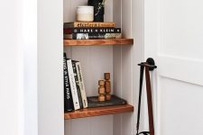 33 a tiny nook done with stained shelves, with a basket, books, candles and a potted plant is a lovely idea for any room