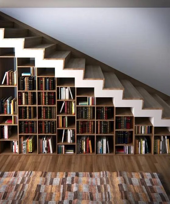 a whole under stairs bookcase features many books and can hold some other objects, too, if needed