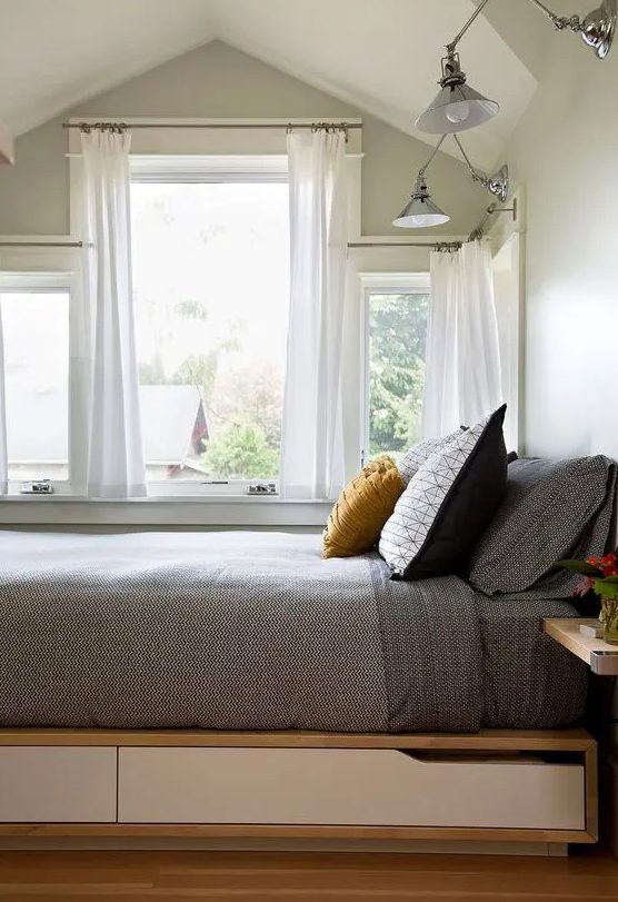 a platform with white drawers acts as a bed - that is a very creative and cool idea to rock