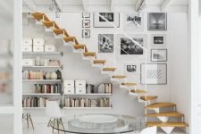 34 an airy whitewashed Scandinavian space with floating bookshelves under the stairs – this space can also act as a home office