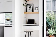 35 a tiny nook take by light-stained built-in shelves and even a tiny built-in desk for working here