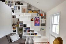 35 bookshelves built in into the wall and staircase for saving space in a small living room