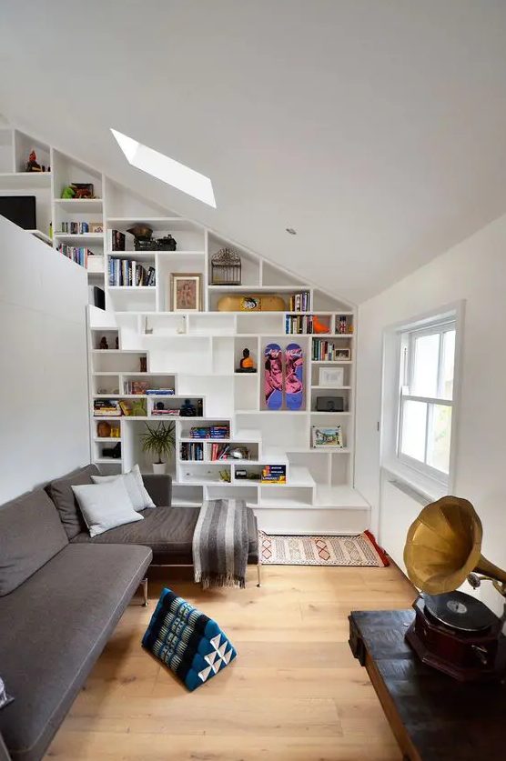 bookshelves built in into the wall and staircase for saving space in a small living room
