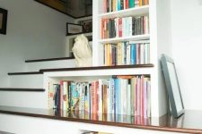 36 bookshelves built-in right into the staircase in a smart and a creative way  to use every inch of space