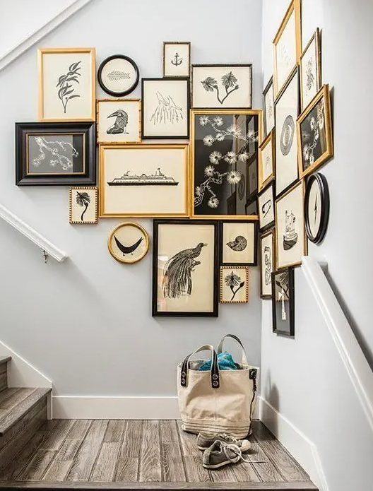 an awkward staircase corner with a gallery wall in gold, white and black for a cool and vintage-inspired look