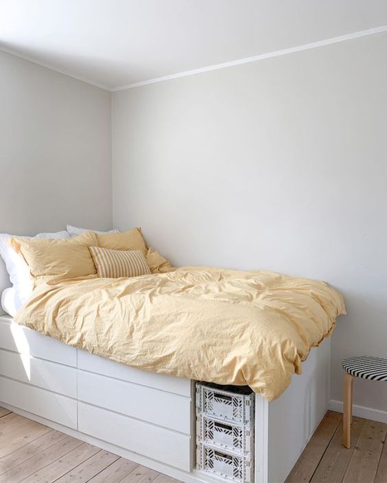 a white storage bed with lots of drawers and an open storage compartment is a lovely idea for a small bedroom