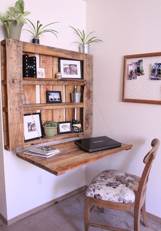 a DIY rustic Murphy desk made of a stainned pallet and chains that hold the desktop in a very secure way and with display space