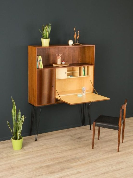 a Murphy desk integrated into a mid-century modern storage unit with hairpin legs, the unit features much storage