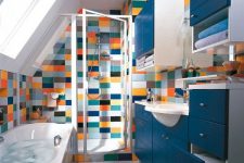 a beautiful bathroom in white and navy, with a bathtub and a shower space clad with colorful tiles plus a turquoise rug