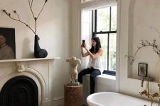 a lovely bathroom with a faux fireplace