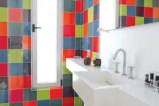 a contemporary bathroom clad with super bright tiles but with a white built-in vanity and shelf plus a bold rug is amazing
