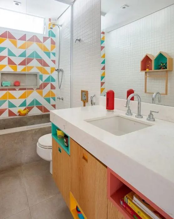 a contemporary bathroom done with much concrete and stone, with a colorful tile accent wall and matching colorful touches