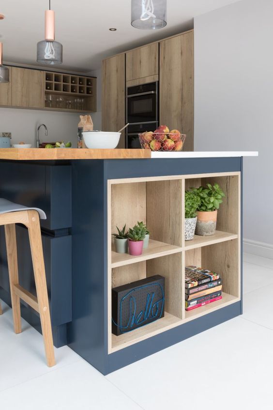 a contemporary kitchen with stained cabinets, a large navy kitchen island with wooden countertops and open shelves for storage