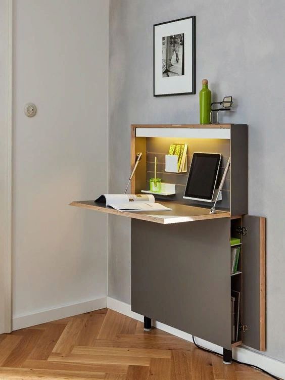 a grey Murphy desk that includes some storage space and a built-in lamp, some neon green touches is super smart