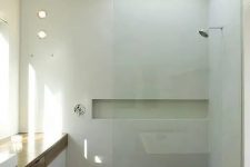 a minimalist bathroom with a spa feel, with a walk-in shower with a wooden floor, a skylight and a large vanity