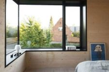 a cozy minimalist bedroom design with wood walls