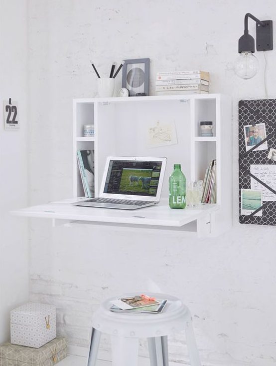 a minimalist white Murpy desk with storage compartments and a small desktop plus a white stool for an airy space