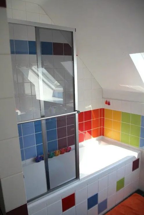 a modern bathroom clad with white and colorful tiles feels like a rainbow and adds a cheerful feel to your home