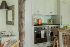a modern farmhouse kitchen with white cabinets, a kitchen island with butcherblock countertops, blonde wood stools and a reclaimed aged wooden beam