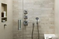 a walk-in shower covered with wood tiles