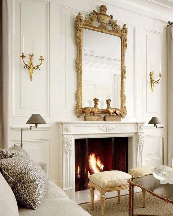 a neutral living room with a chic working fireplace that is accented with a vintage frame mirror that adds style