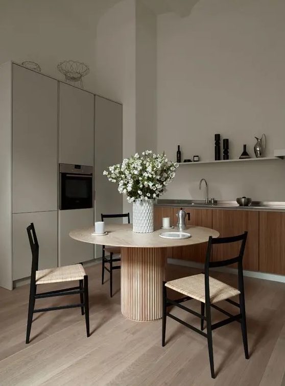 a refined minimalist kitchen with a dining space, with light-stained wood with various tones is a very chic and cool idea