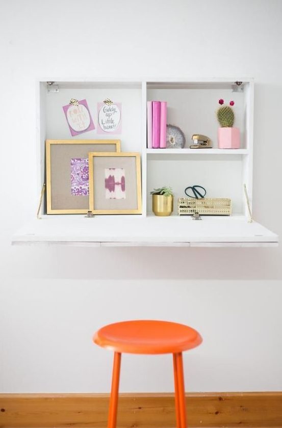 a simple white Murphy desk with some storage space inside and a large desktop is a comfortable workspace