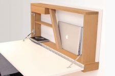 a stylish modern Murphy desk with a white desktop and a plywood base on the wall features soem storage space for holding your laptop