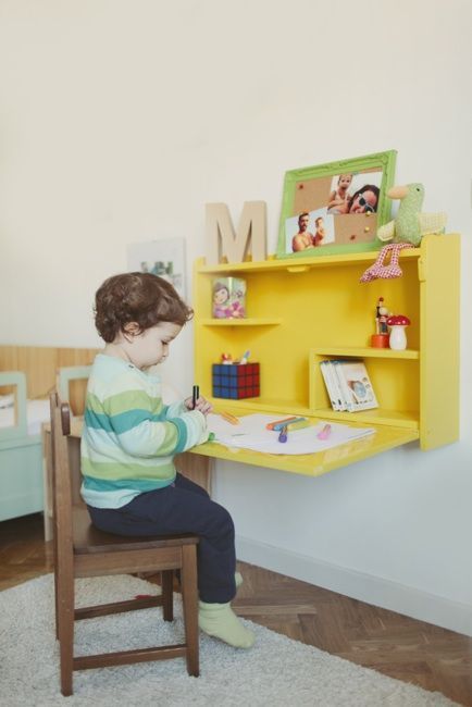 a sunny yellow Murphy desk with toys, photos and monograms is a great solution for a kid's room