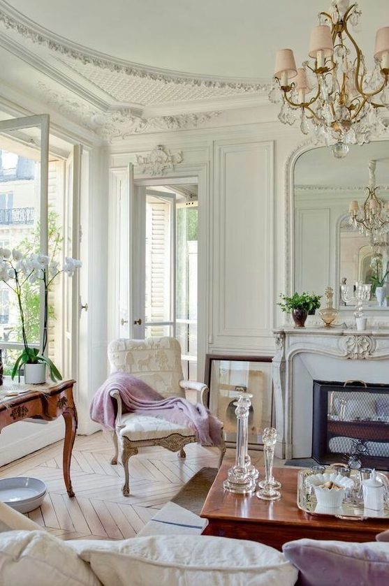 a super elegant living room with a Parisian feel and hardwood parquet floors of a neutral warm shade