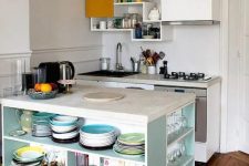 a tiny kitchen with white cabinets, neutral countertops, catchy upper cabinets, a light blue kitchen island with open shelves for storing anything necessary