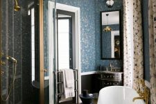 a lovely bathroom with a blue wallpaper