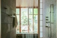 an East-inspired walk-in shower with a wooden floor, stone-like tiles and a rain shower for a real spa-like feel