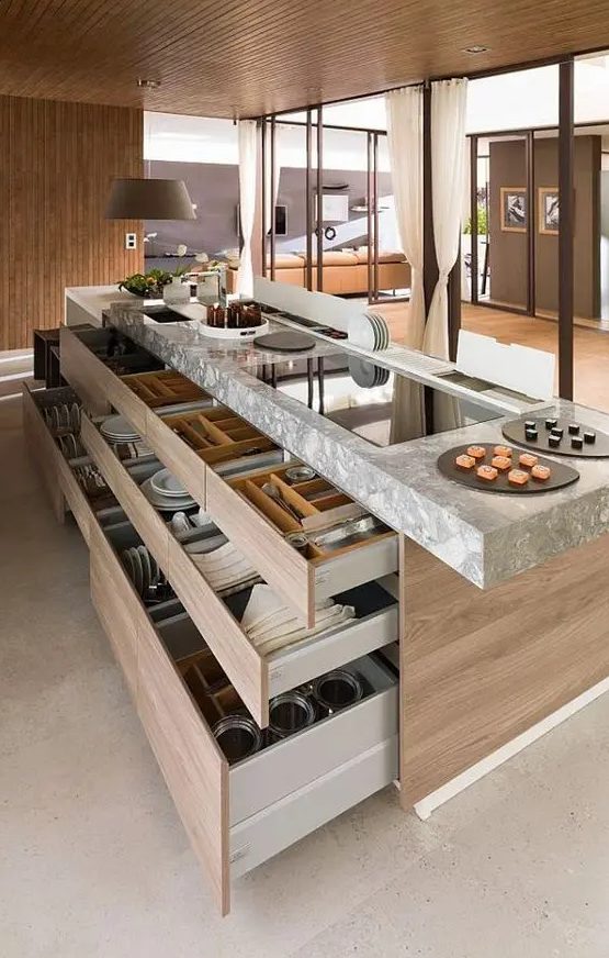 an oversized kitchen island with drawers for storing evrything, with a grey stone countertop is enough, you won't need any cabinets with it
