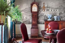 02 a beautiful vintage dining room with a mural, a rich-stained dining table, burgundy leathr chairs, a stained credenza, teal curtains and greenery plus a grandfather clock