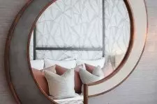 02 a chic sculptural mirror in white and grey, with copper framing is a beautiful decoration that will add light