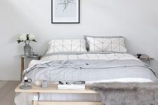 03 a casual Nordic bedroom in off-whites, with a wooden bench, a comfy bed and a pendant lamp for a modern look