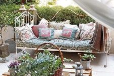 05 a super elegant and French chic forged daybed with lots of pillows on casters is a great piece for a romantic area
