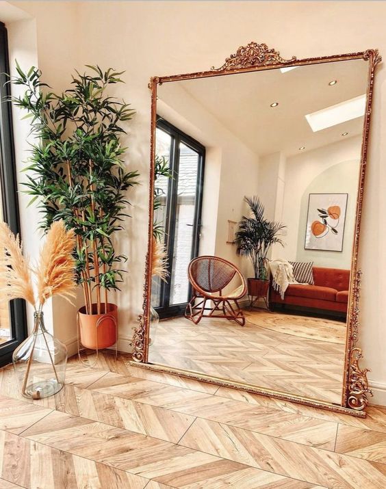 an oversized mirror in a chic vintage frame can take a whole wall, can fill the space with light and you may use it for composing your outfits