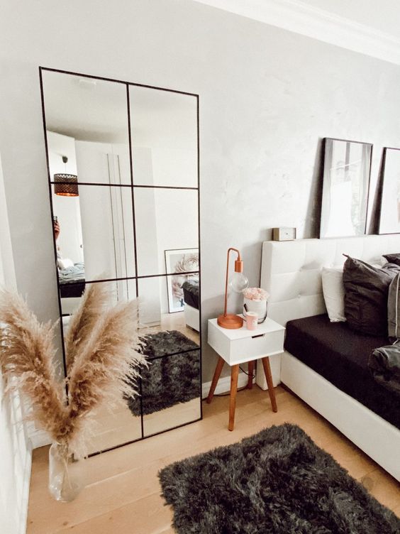 an IKEA mirror hack with frames can take a blank wall and make your space look bigger plus you may use it for composing outfits