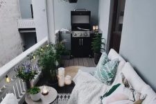 08 a cozy Nordic balcony with potted plants, printed textiles and a grill – all you need in one