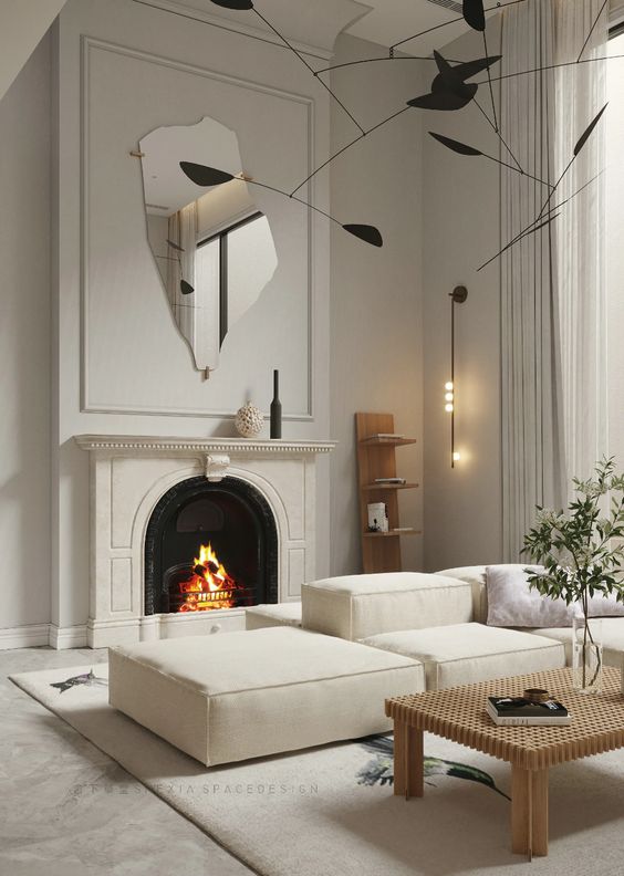 a refined neutral space with a fireplace, elegant neutral furniture, a catchy black chandelier and a uniquely shaped mirror over the fireplace