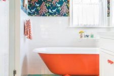 a cozy bathroom with a floral wallpaper