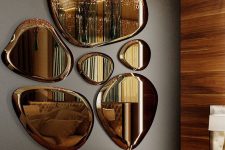 09 an arrangement of beautiful cognac-colored mirrors of unusual shapes, with crystals over the bench for glam bedroom styling