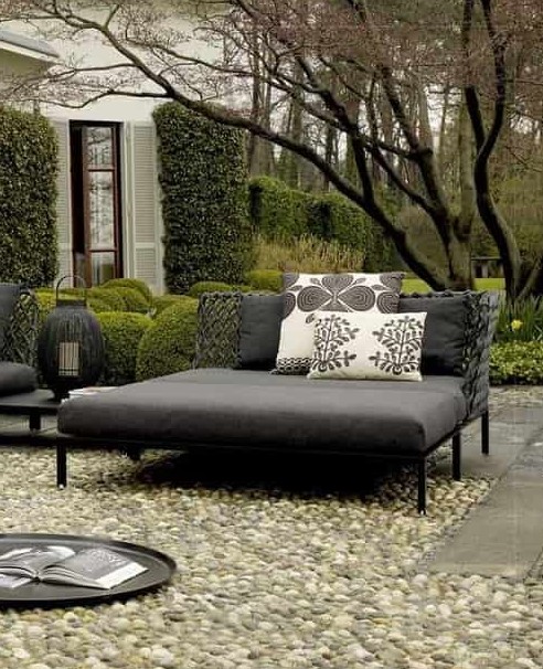 a contemporary dark daybed with printed pillows will accommodate more than one person and will add a modern feel to the space