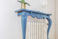 10 a radiator covered with a refined vintage blue console half table, with some decor will add elegance to your space