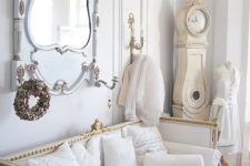 11 a luxurious interior in white, pastels and gold, with an antique mirror and a vintage clock in the corner is a lovely and refined space to be
