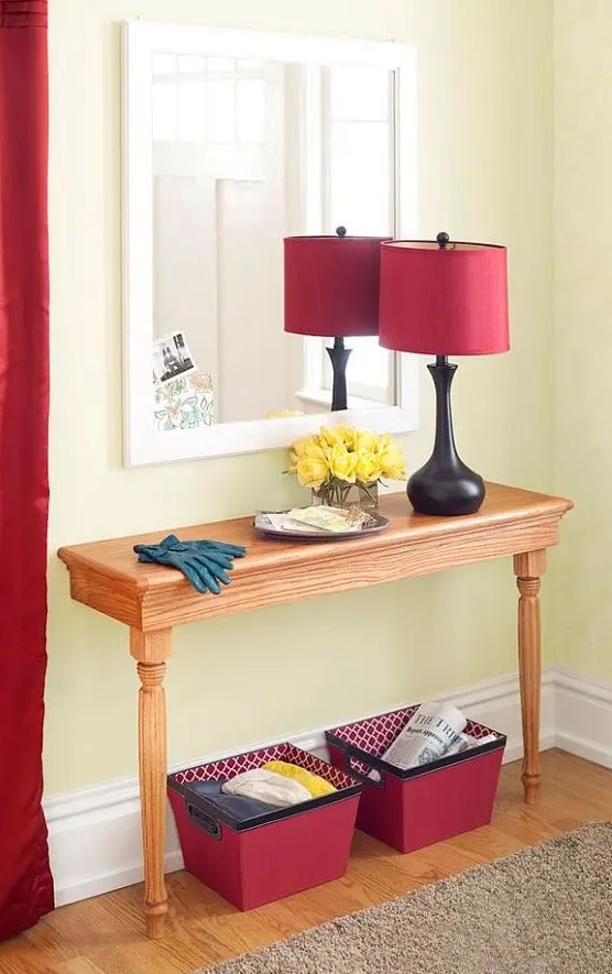 a simple wooden half table as an entryway console will hold everything you need and won't take much of the precious floor space