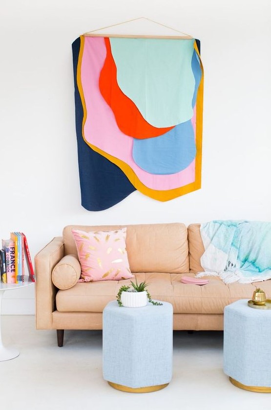 a bright and fun fabric wall hanging over the sofa infuses the space with color and makes it bold and fun
