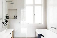 21 a refreshing Scandinavian bathroom with white walls, an oval tub, a long white vanity and a jute rug